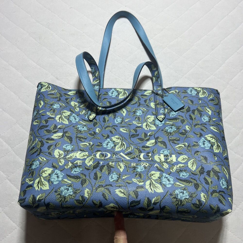This Coach Highline Tote features a distinctive blue Sleeping Rose floral print